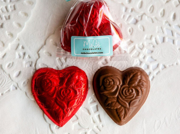 Rose-adorned solid milk chocolate hearts wrapped in red foil, from Mr. B's Chocolates